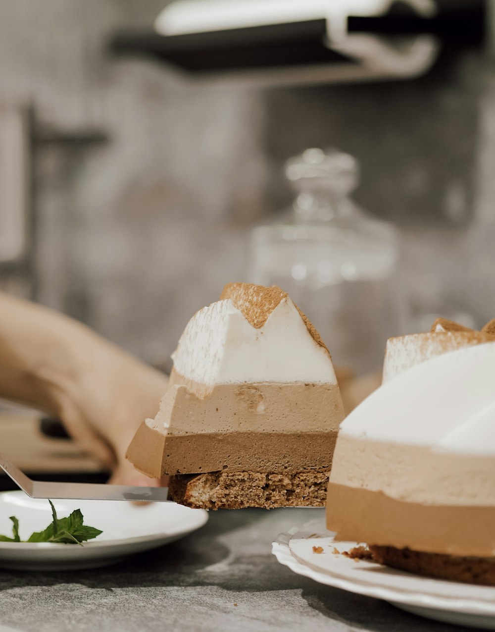 a table topped with slices of cake next to plates of food