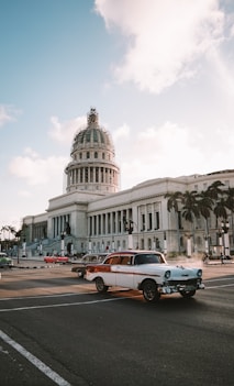 different vehicles on road viewing white dome historic building during daytime