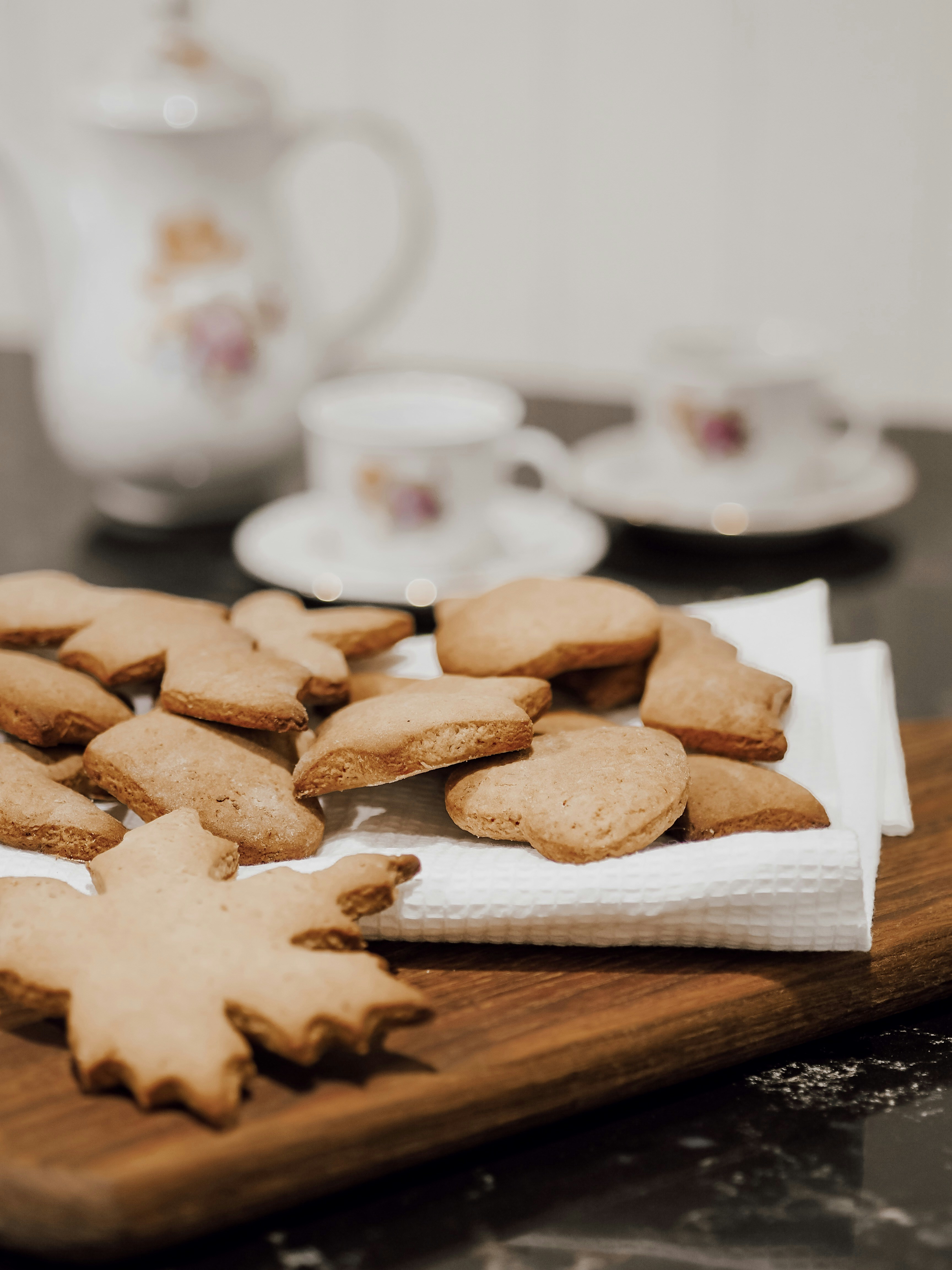 a wooden cutting board topped with cut up cookies