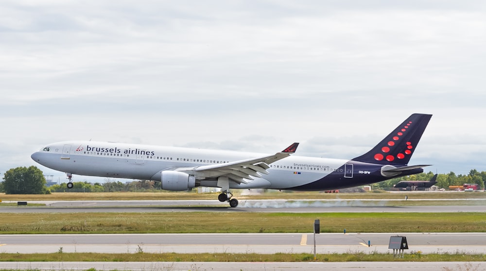 Brussels Airlines airliner about to take off from airfield during day