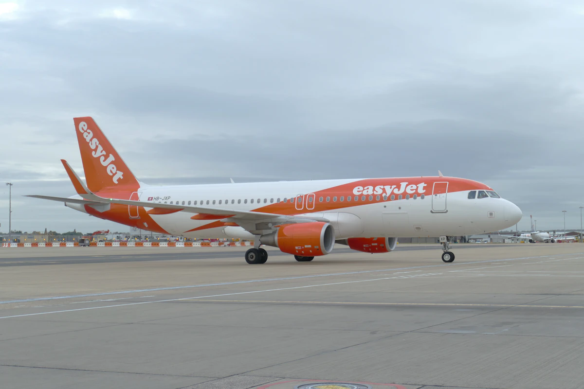 An airliner on a runway at a busy commercial airport