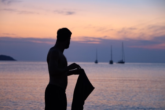 silhouette of person holding tops in Menorca Spain