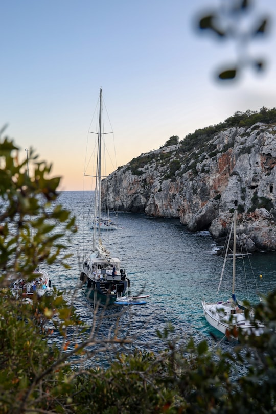 white powerboats on body of water near mountain in Menorca Spain