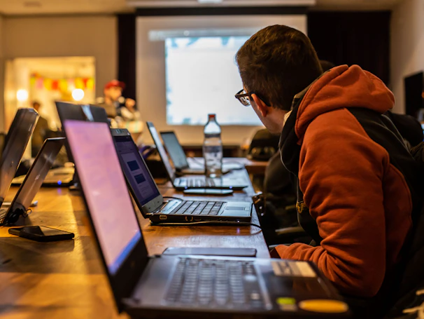 man sits in front of laptop
