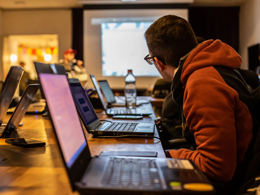 Bootcamp student writing JavaScript on a laptop during an evening coding session