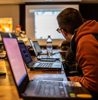 man sits in front of laptop