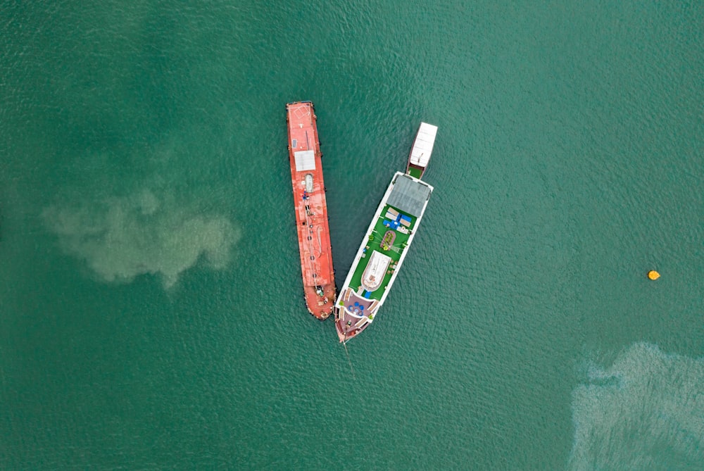 aerial photography of two boats on green sea during daytime