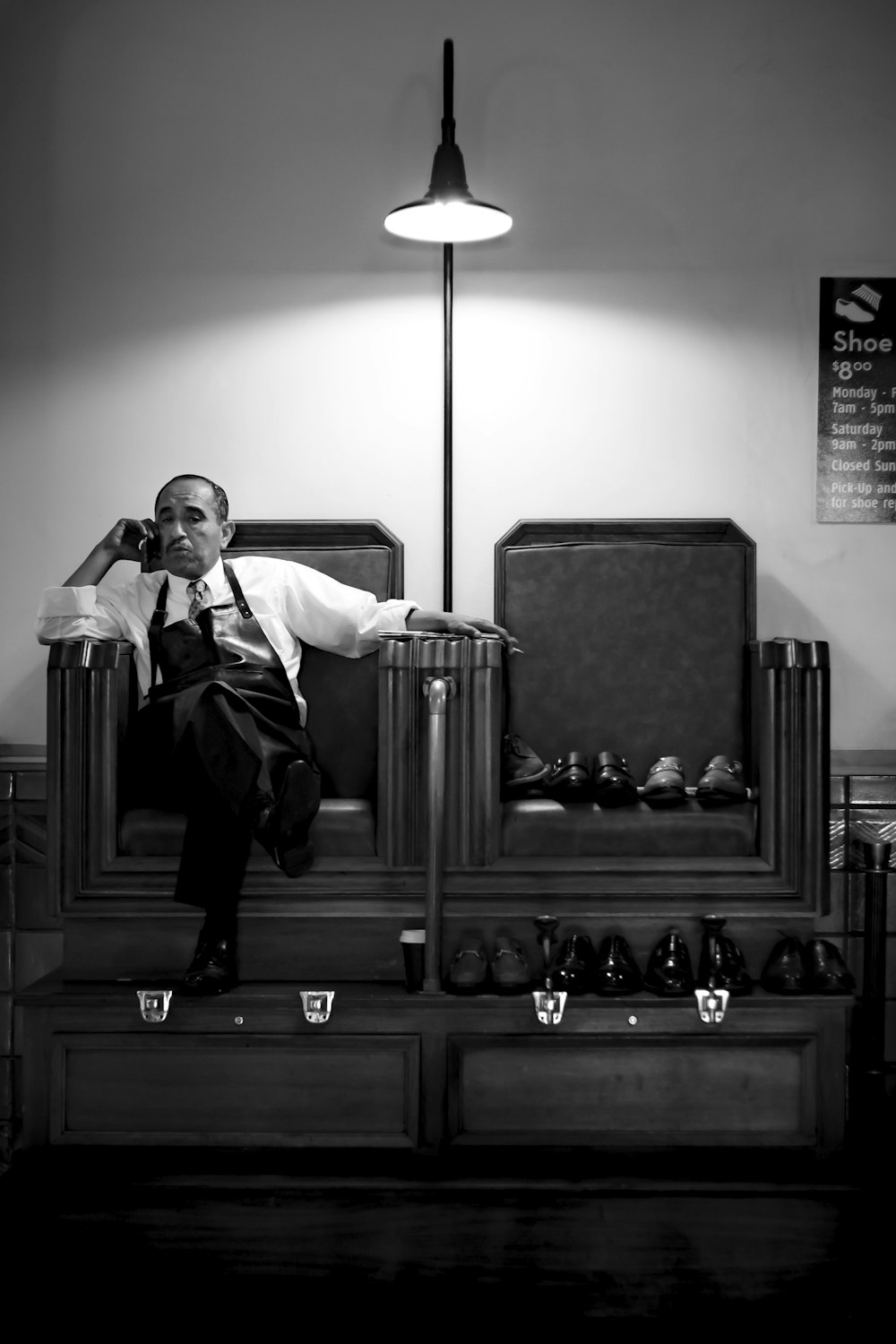 grayscale photography of man sits on chair