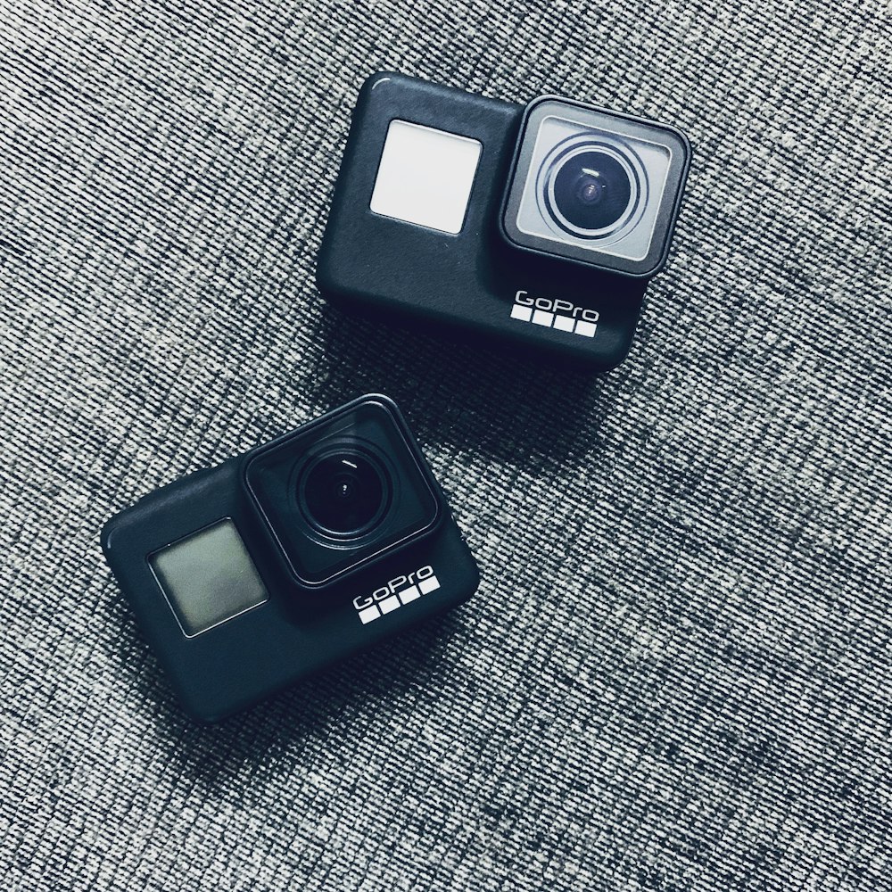 two black GoPro Hero action cameras