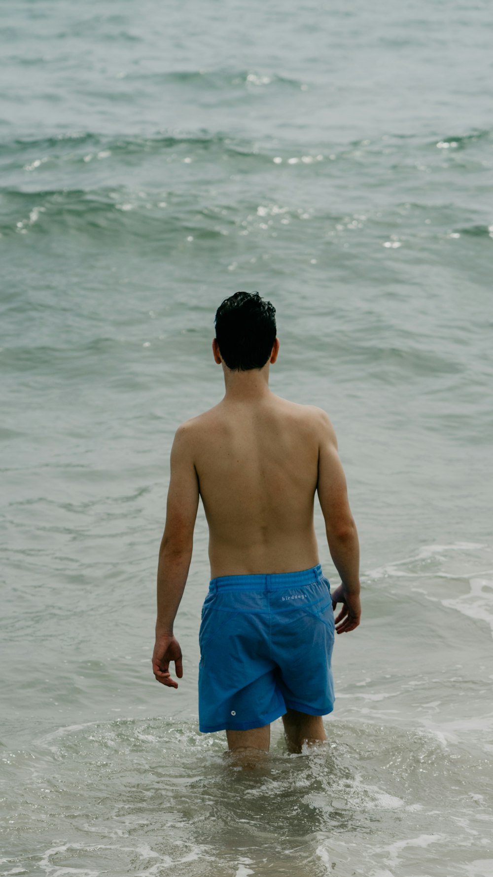 man standing near ocean