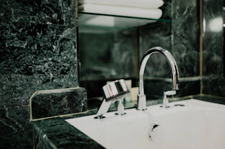 Shiny bathroom fittings installed in a modern, bright bathroom setting.