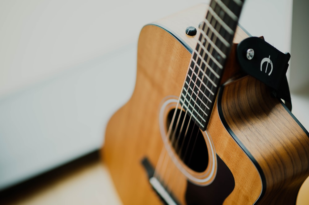 brown cutaway acoustic guitar