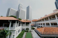 Historic colonial architecture blending with modern skyscrapers in a city center.