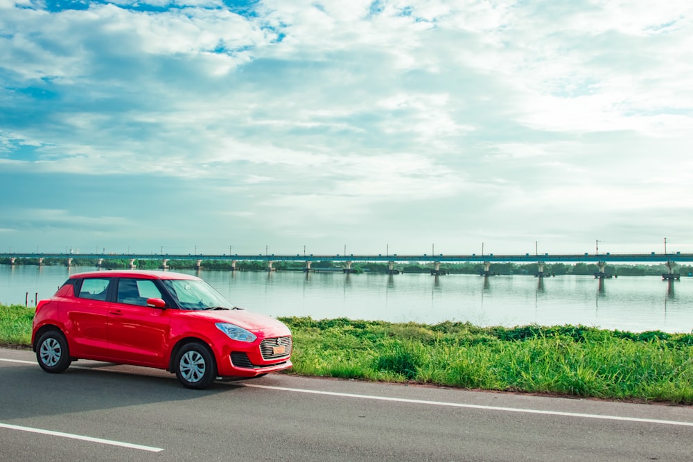 red vehicle near ocean