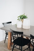 A styled dining table showcasing the woven jute mats and enamel canisters in use.