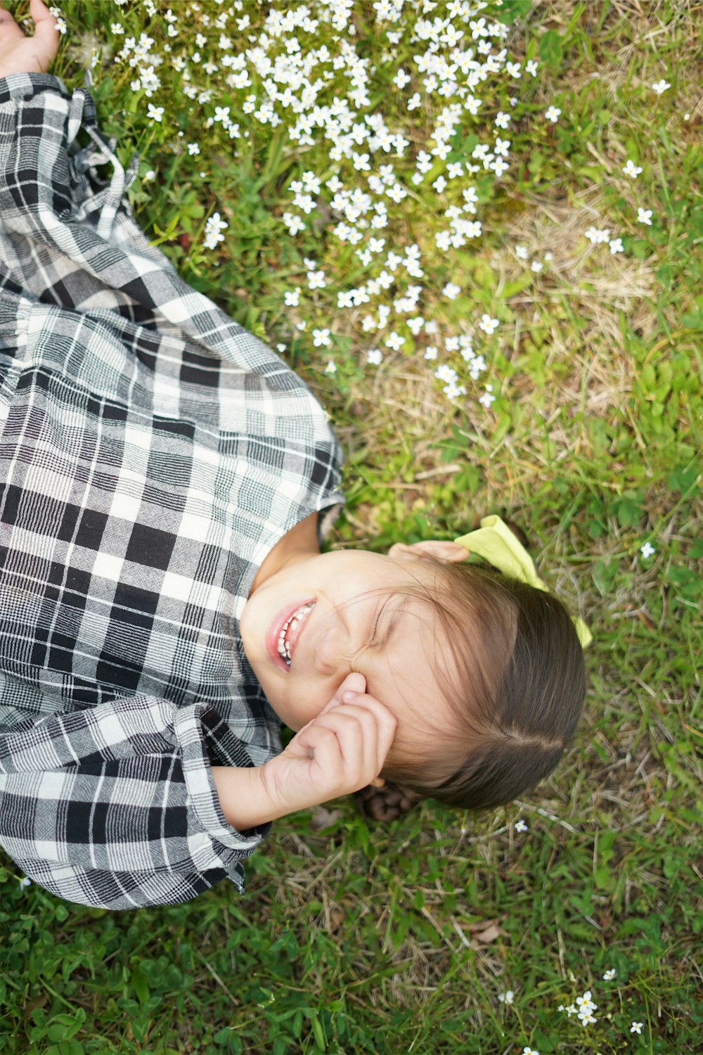 girl lying on grass field