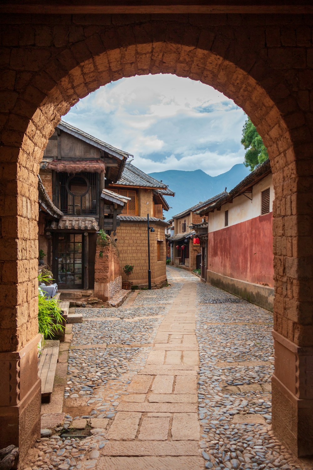 brown pathway between houses during daytime photo