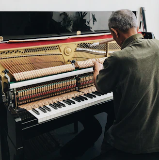 a man sitting at a piano playing a musical instrument