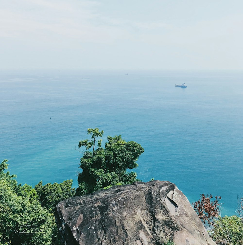 aerial photography of cliff viewing blue sea during daytime