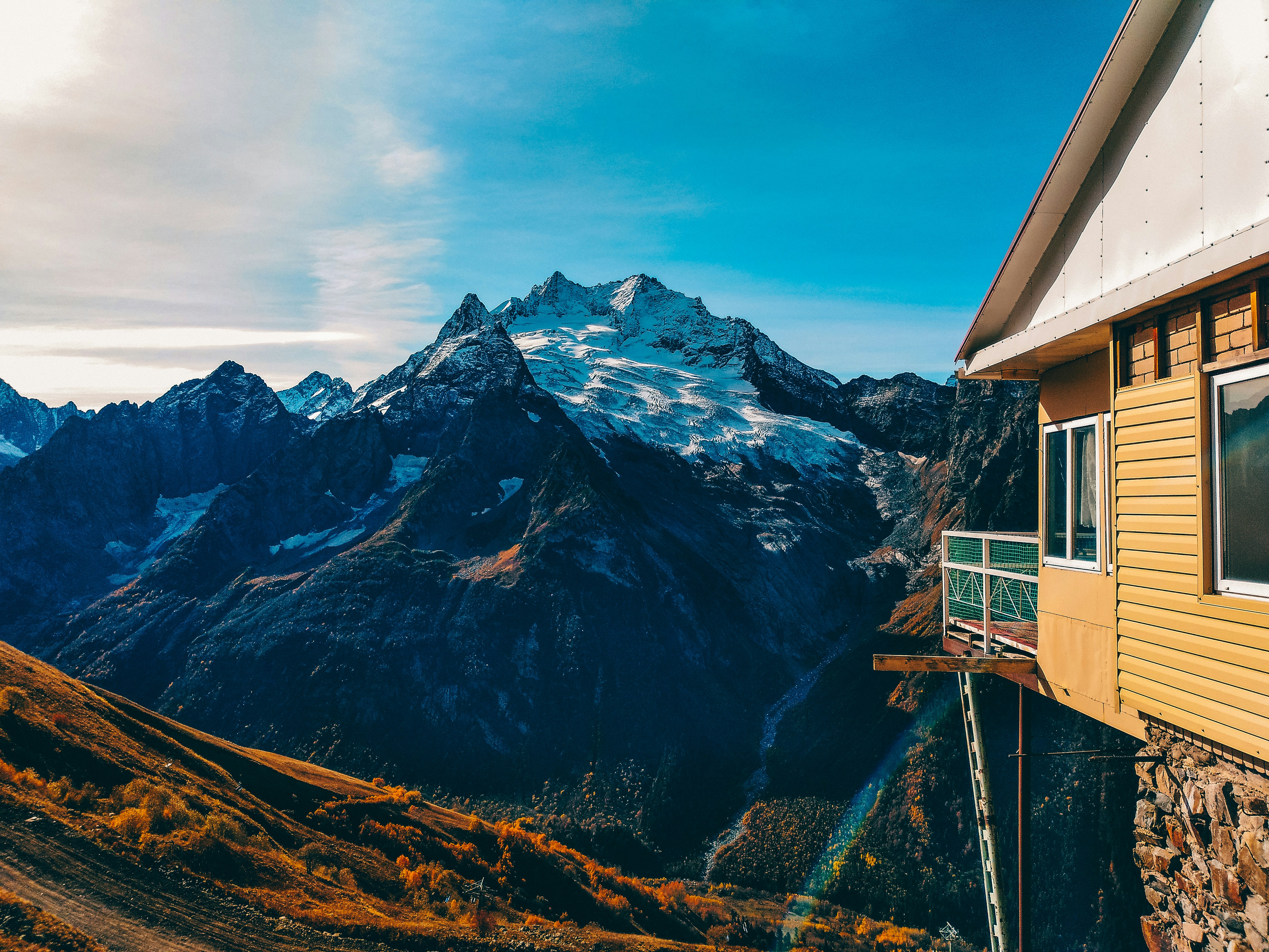 brown wooden house near mountain