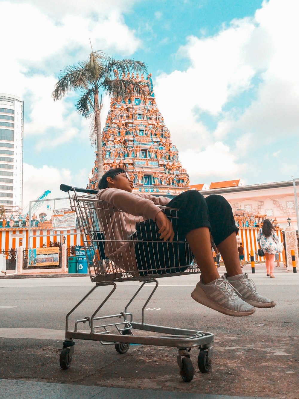 person riding shopping cart during daytime