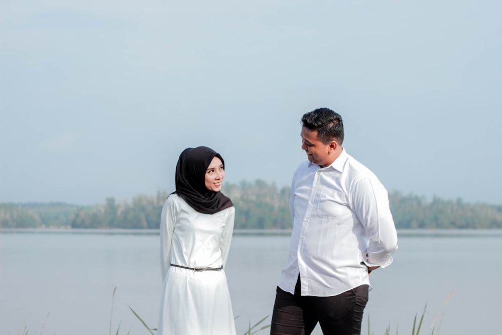 couple standing beside sea