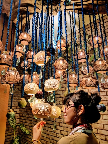 Elegant brass lamps and handcrafted wall hangings brightening a cozy living room.