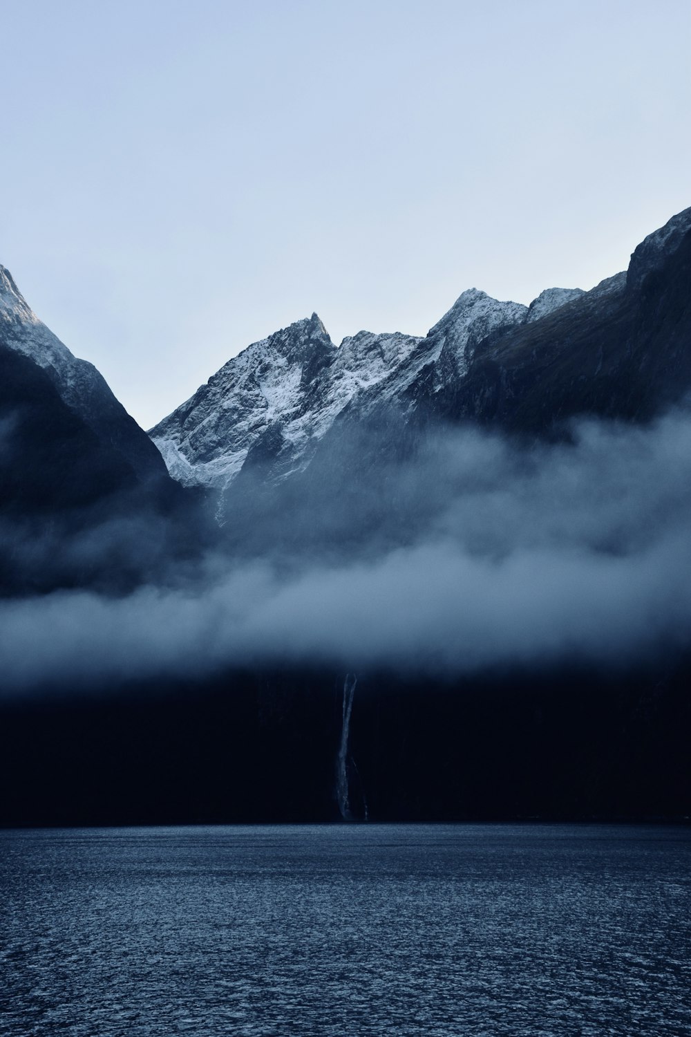 black and white mountain near body of water