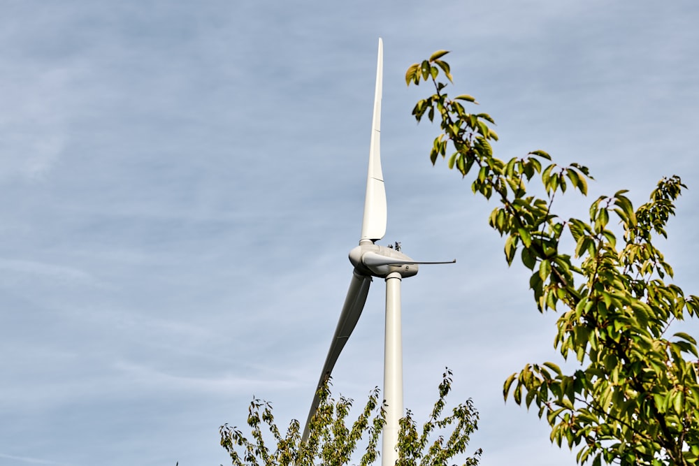 wind turbine near trees at daytime