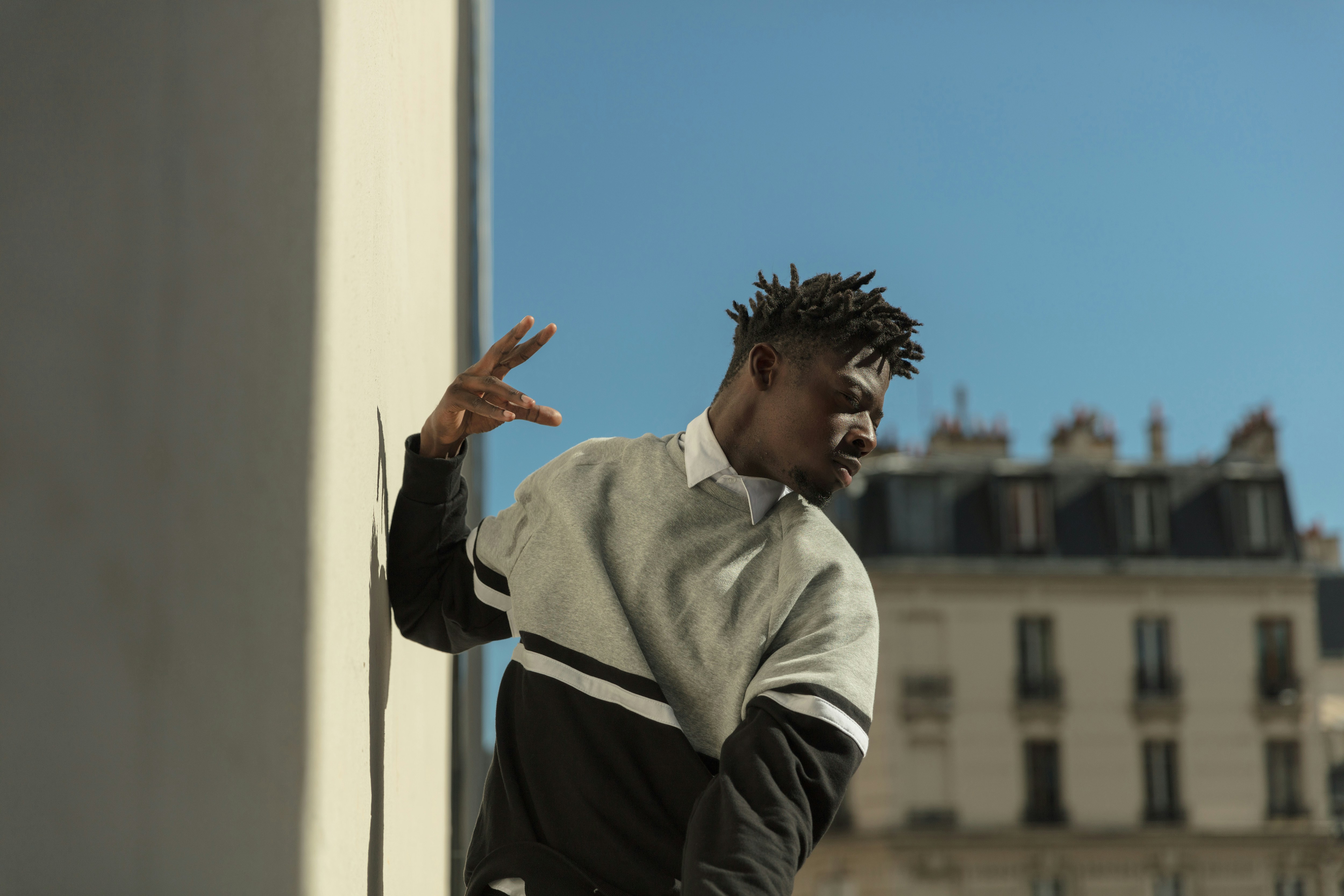 man leaning on concrete wall, Dancing wall