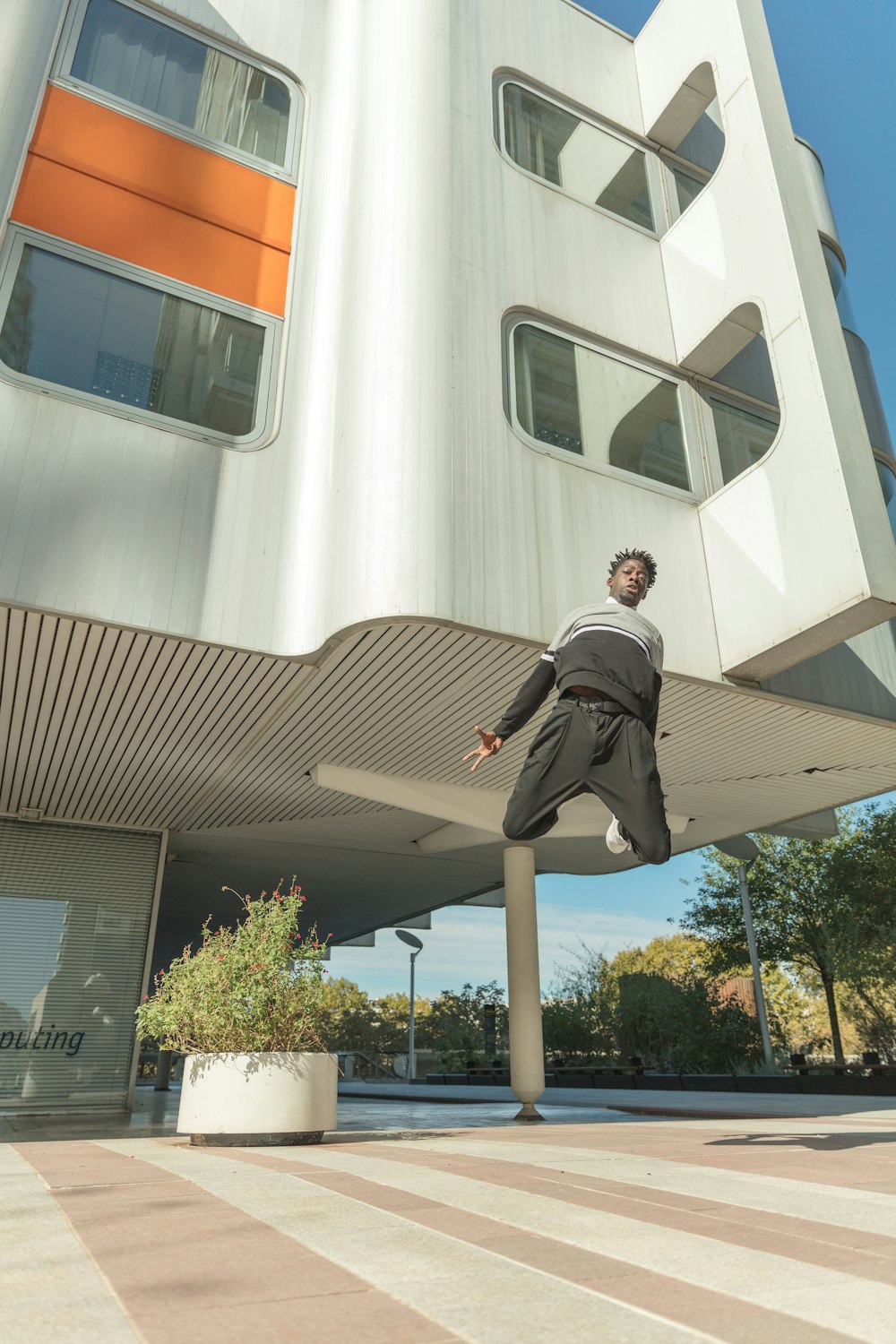 jumping man wearing black pants during daytime