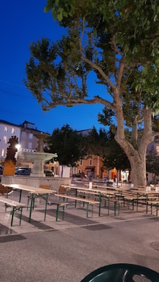Evening scene of a public square redesigned through participatory planning, with people enjoying the space.