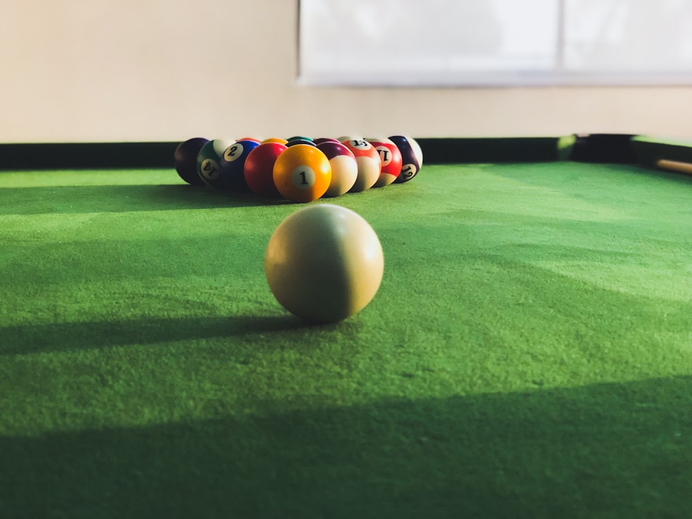 Billiard poll balls set on green poll table