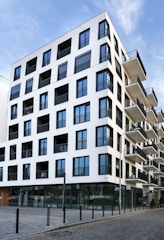 white concrete building beside street at daytime