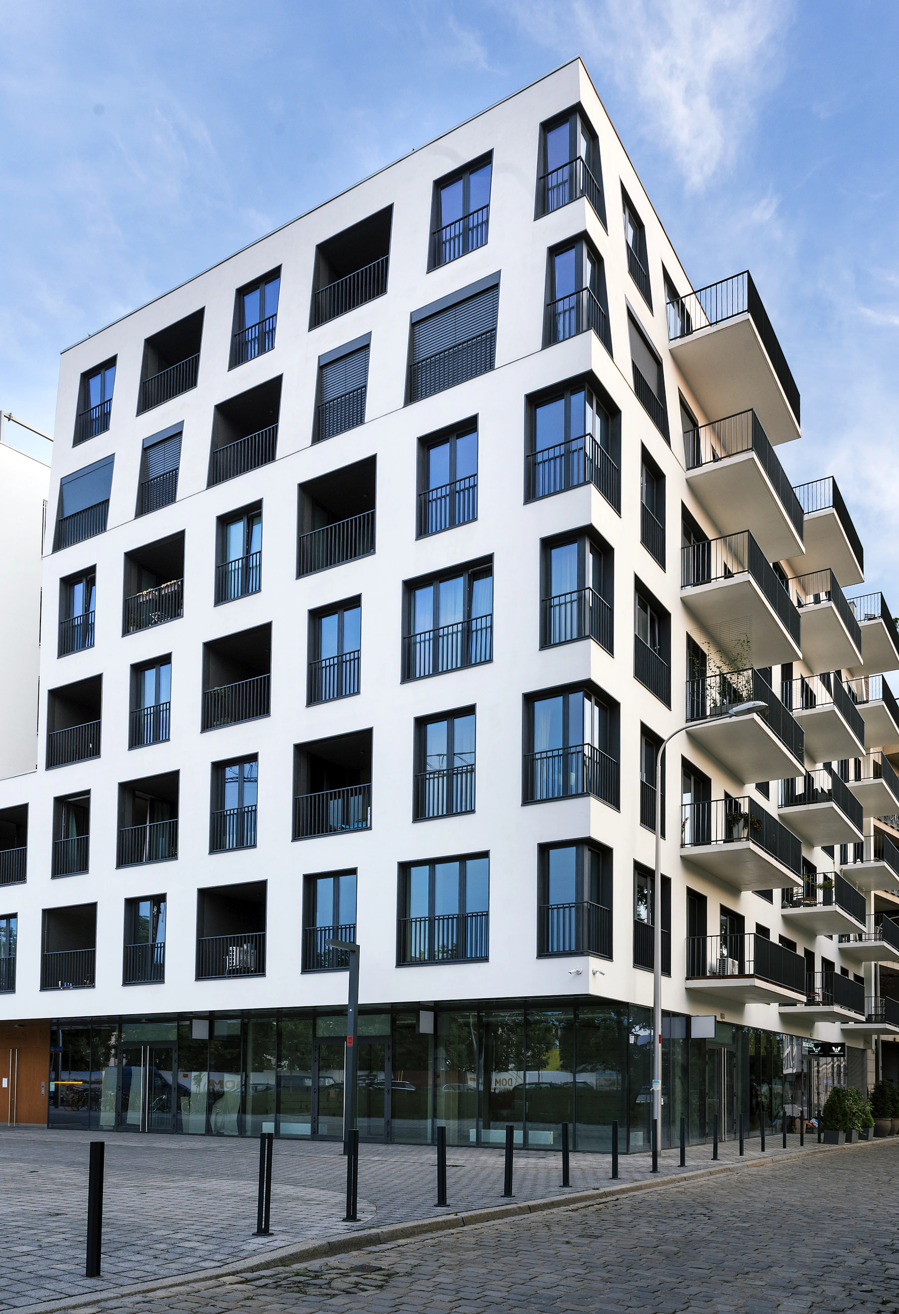 Understated residential architecture with white walls and recessed balconies
