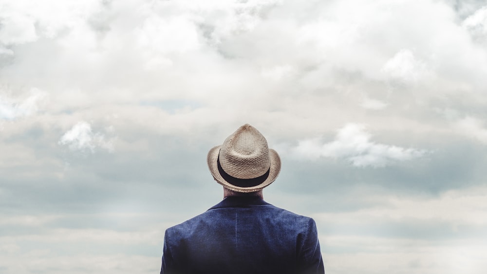 man standing under cloudy sky during daytime