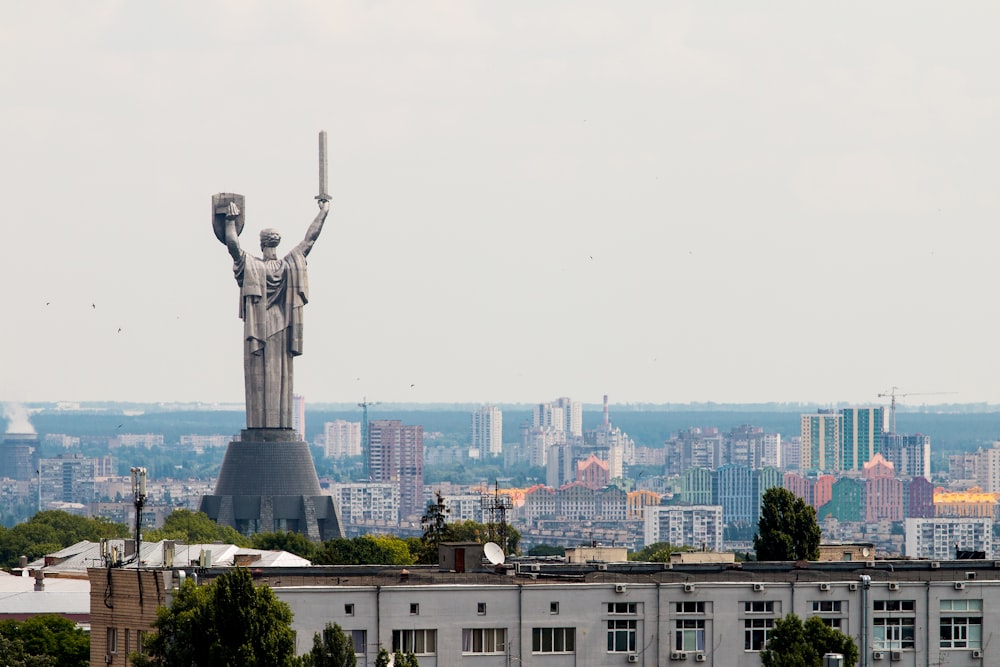 statue of man near buildings