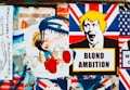 A collage of street art featuring satirical political imagery. The central focus includes a depiction of a child-like character with an elongated nose and blue paint dripping over the face, juxtaposed with another stylized image of a person's face with yellow hair above a sign that reads 'BLOND AMBITION'. The background includes various elements resembling the Union Jack flag.