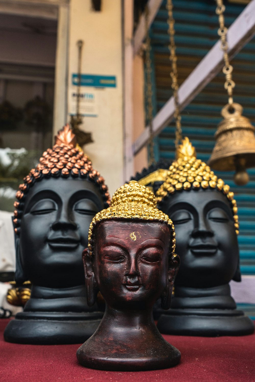 three Buddha head bust
