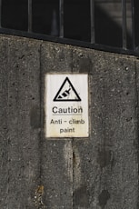 caution anti-climb paint sign
