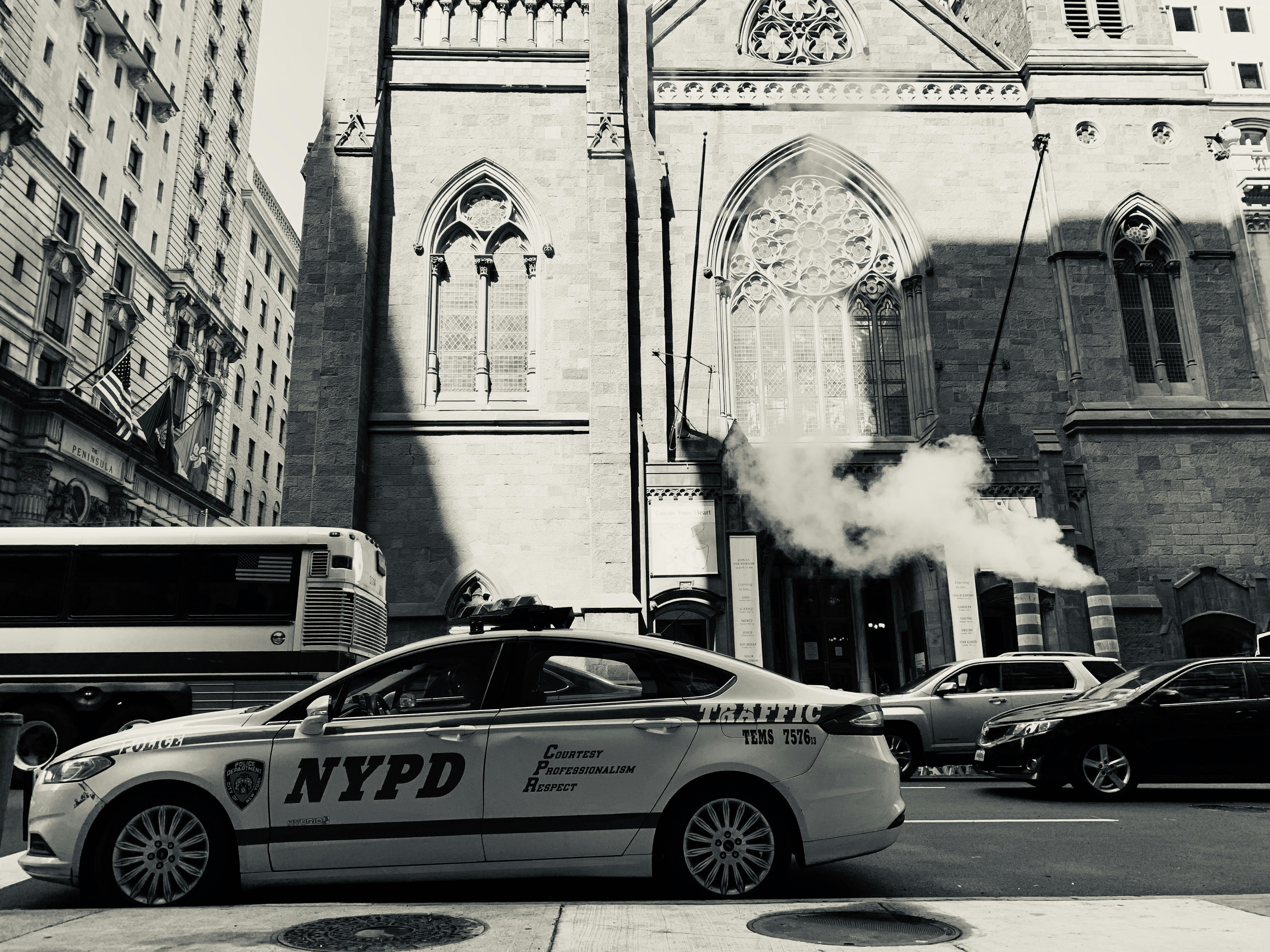 silhouette of NYPD sedan parked on roadside