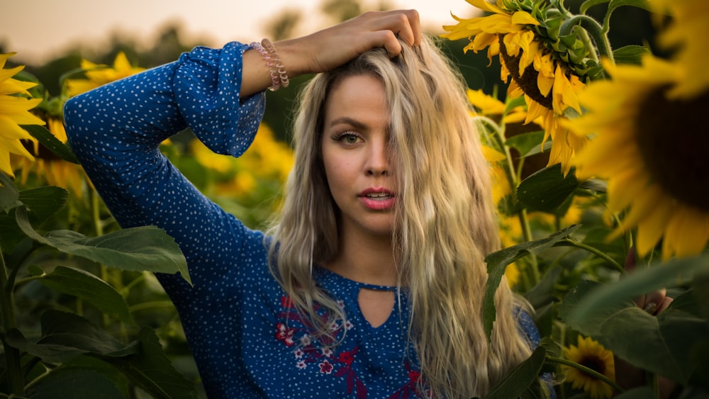 woman surrounded by sunflowers