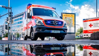 white and red Mercedes-Benz ambulace