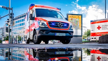 white and red Mercedes-Benz ambulace