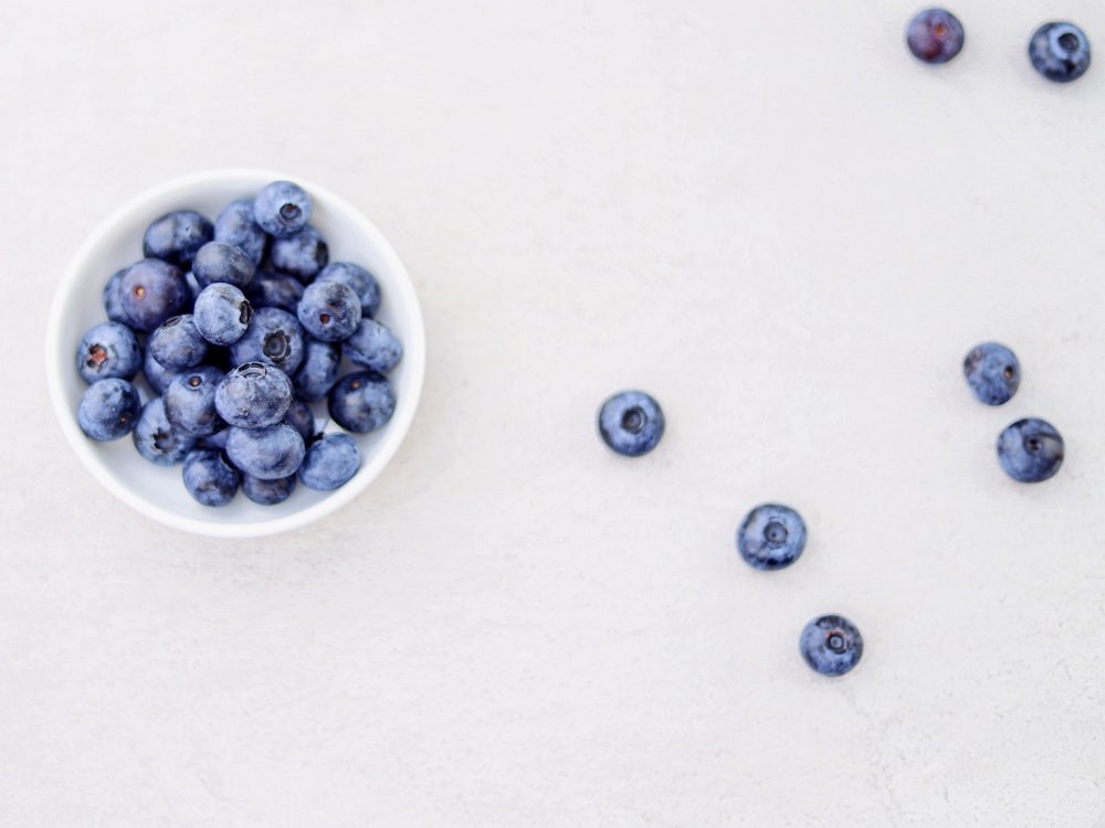 blueberries in bowl and white surface