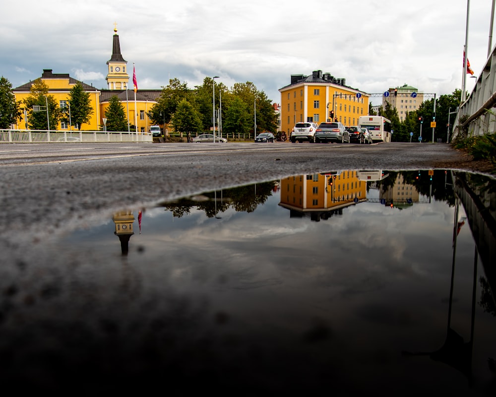 vehicles on road near buildings during day