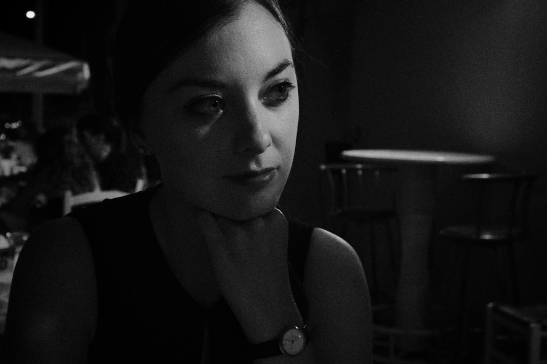 grayscale photo of woman wearing watch