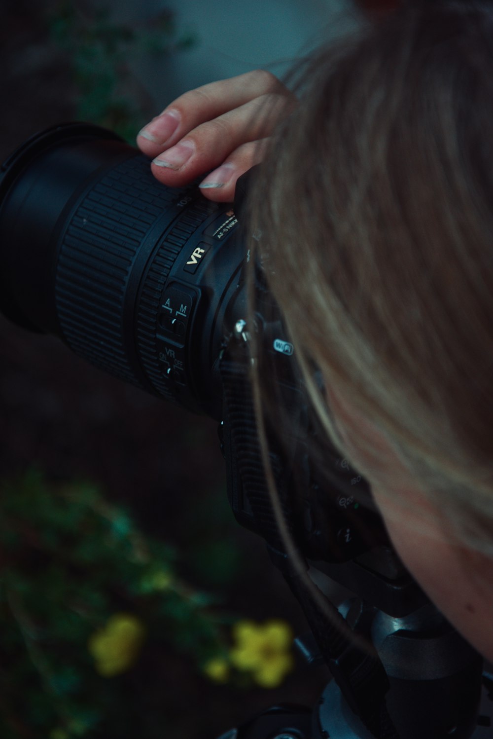 woman holding black DSLR camera