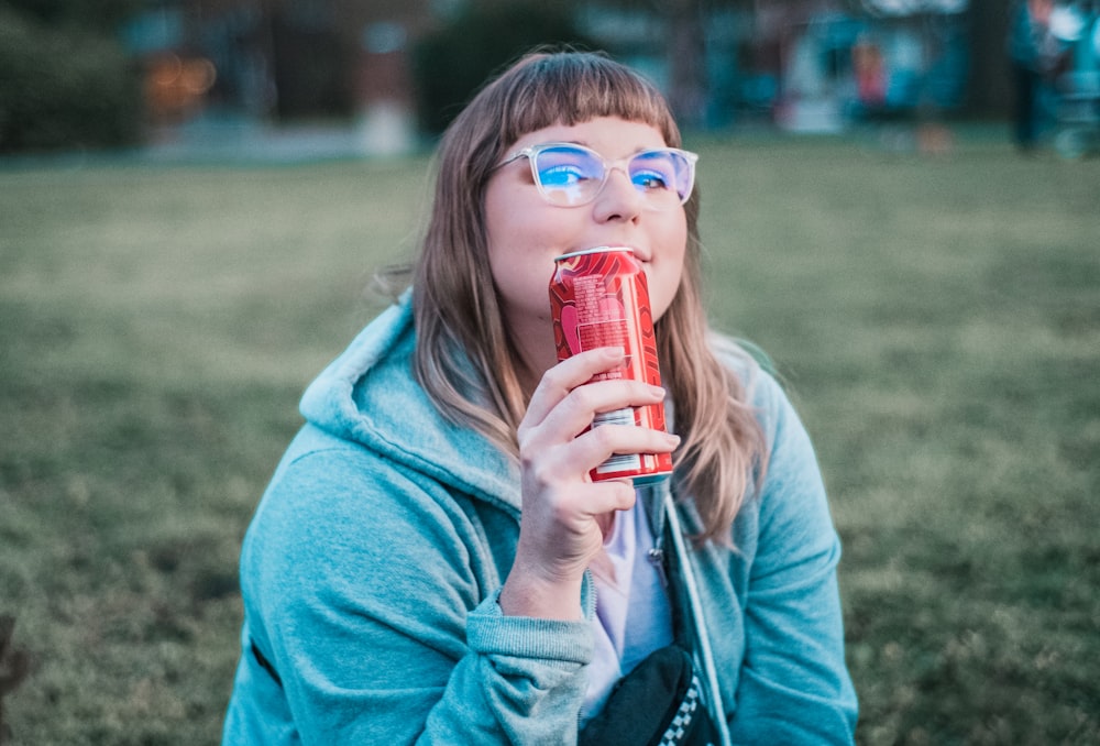 woman holding red can