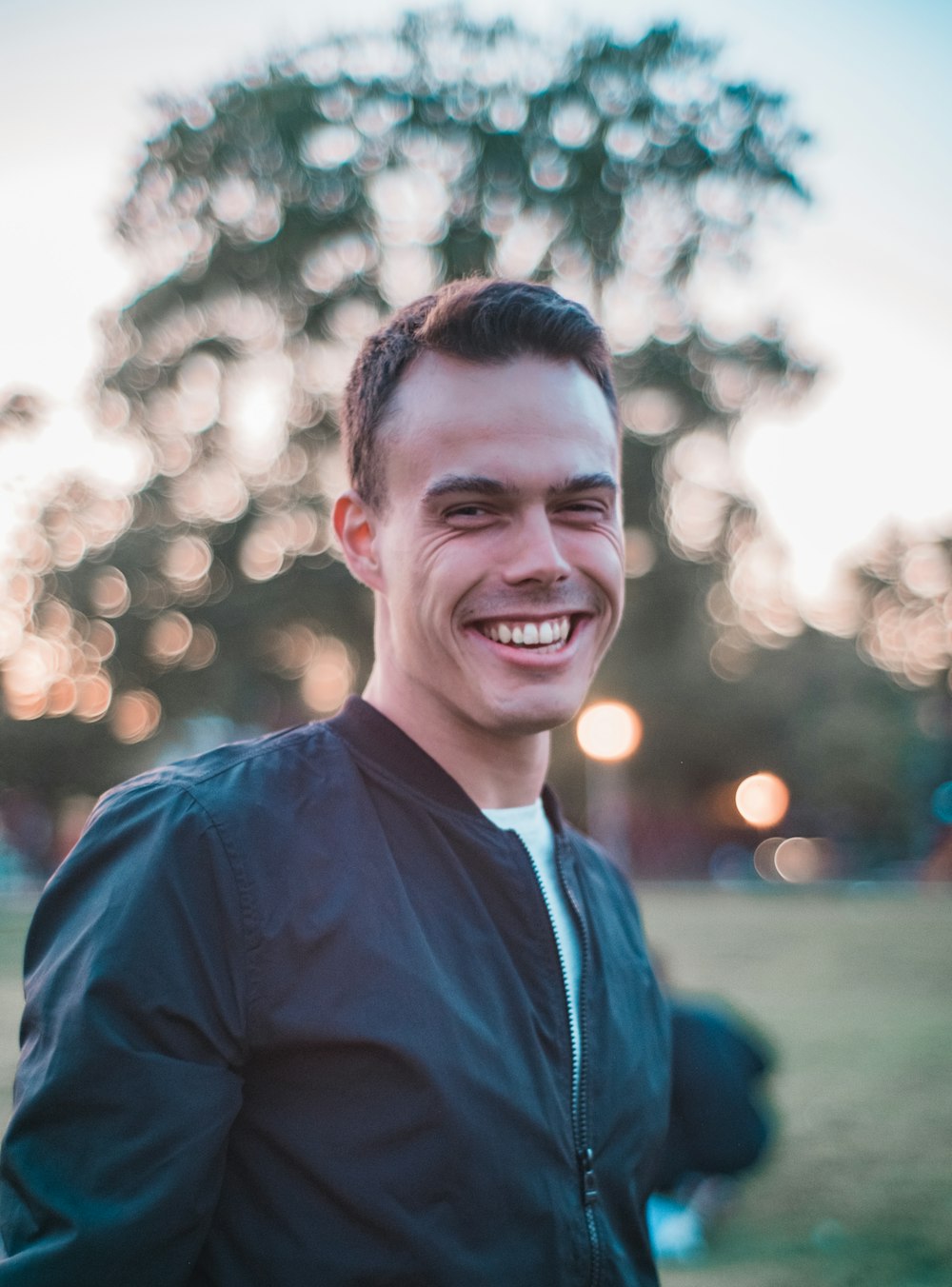 man in black top taking selfie outdoors